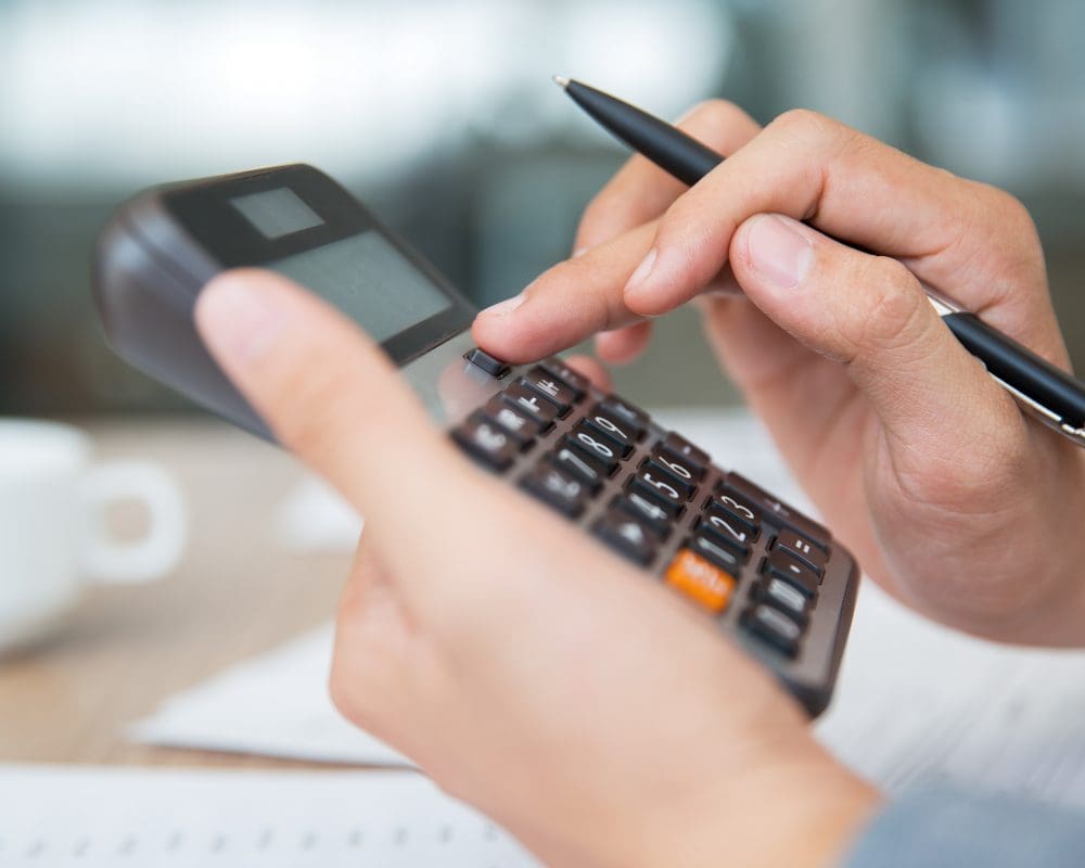 Male hands using calculator