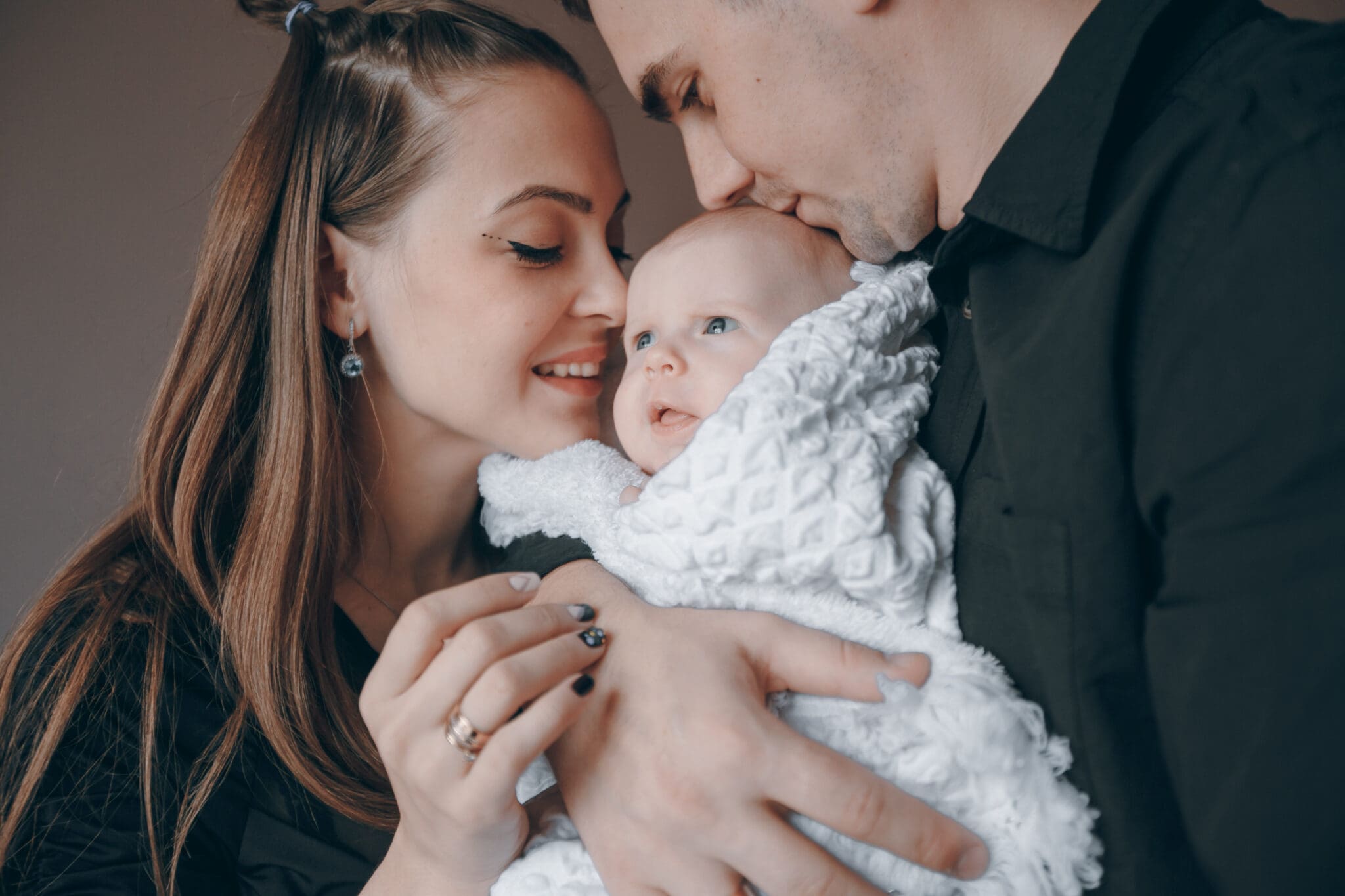Couple cuddling a baby