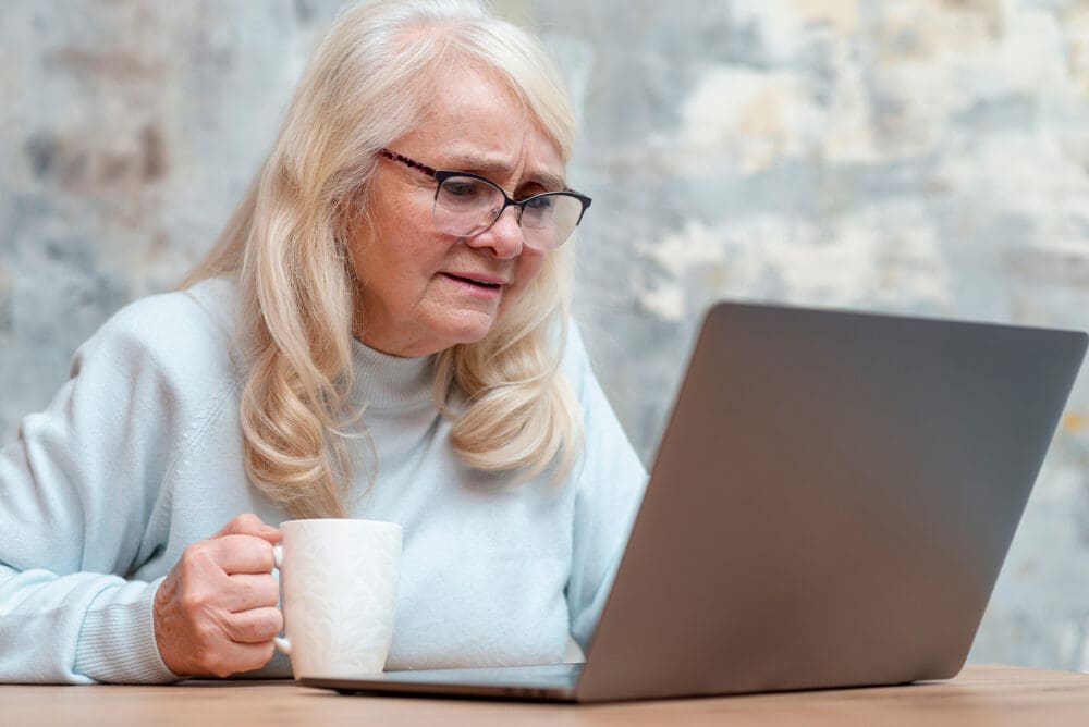 elderly woman using laptop