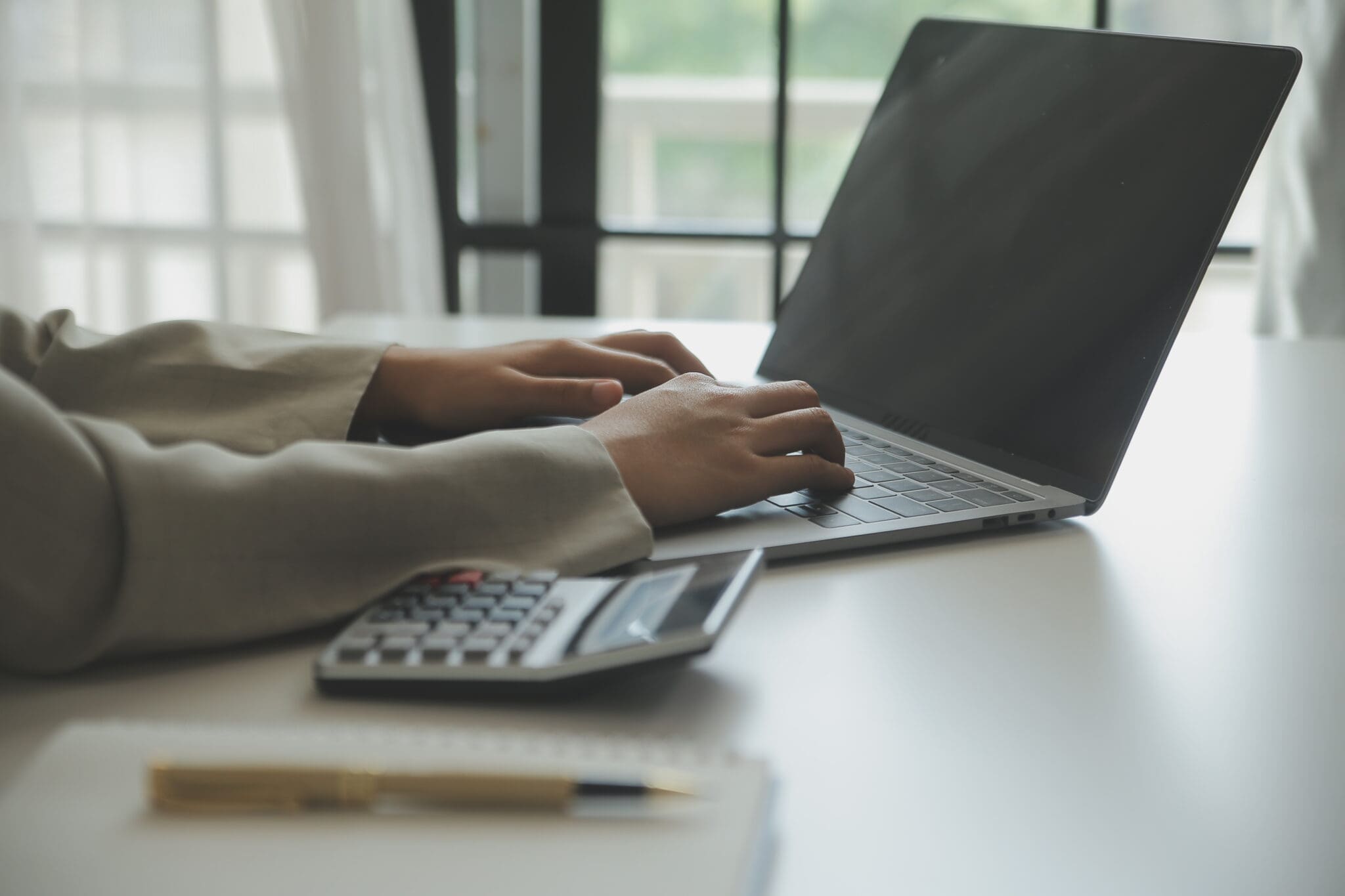 Laptop being typed on a desk