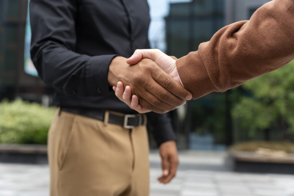 close up of two men shaking hands