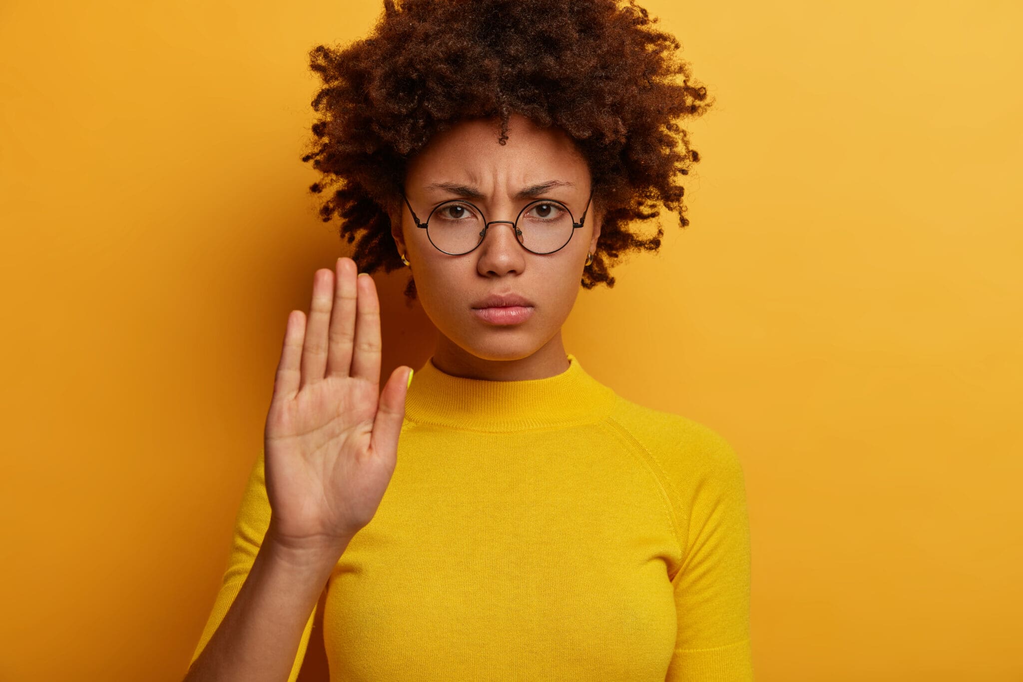 a woman standing with her palm facing forward