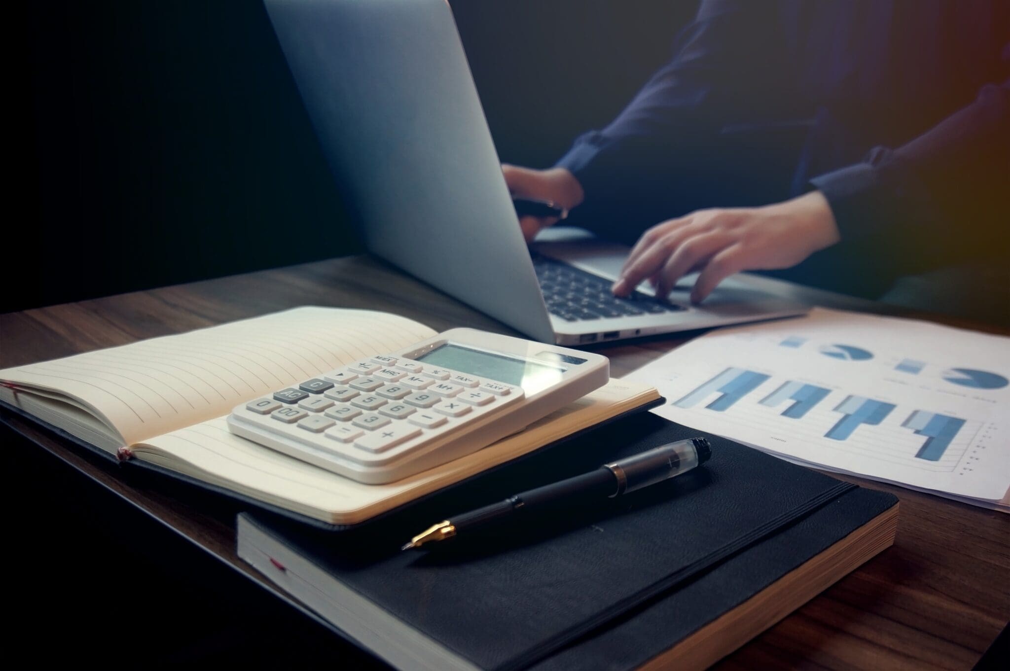Business accounting women work with calculator and Laptop. Financial technology.