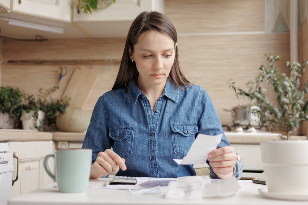 A woman checking over documents from HMRC