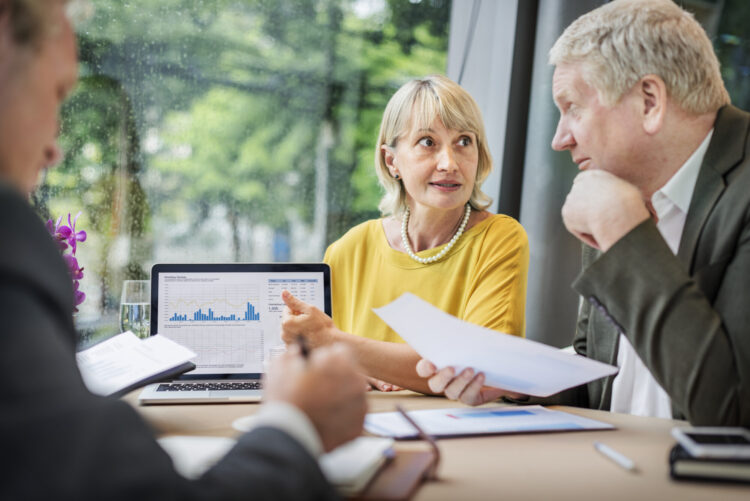 Accountant reviewing VAT calculations with business owners