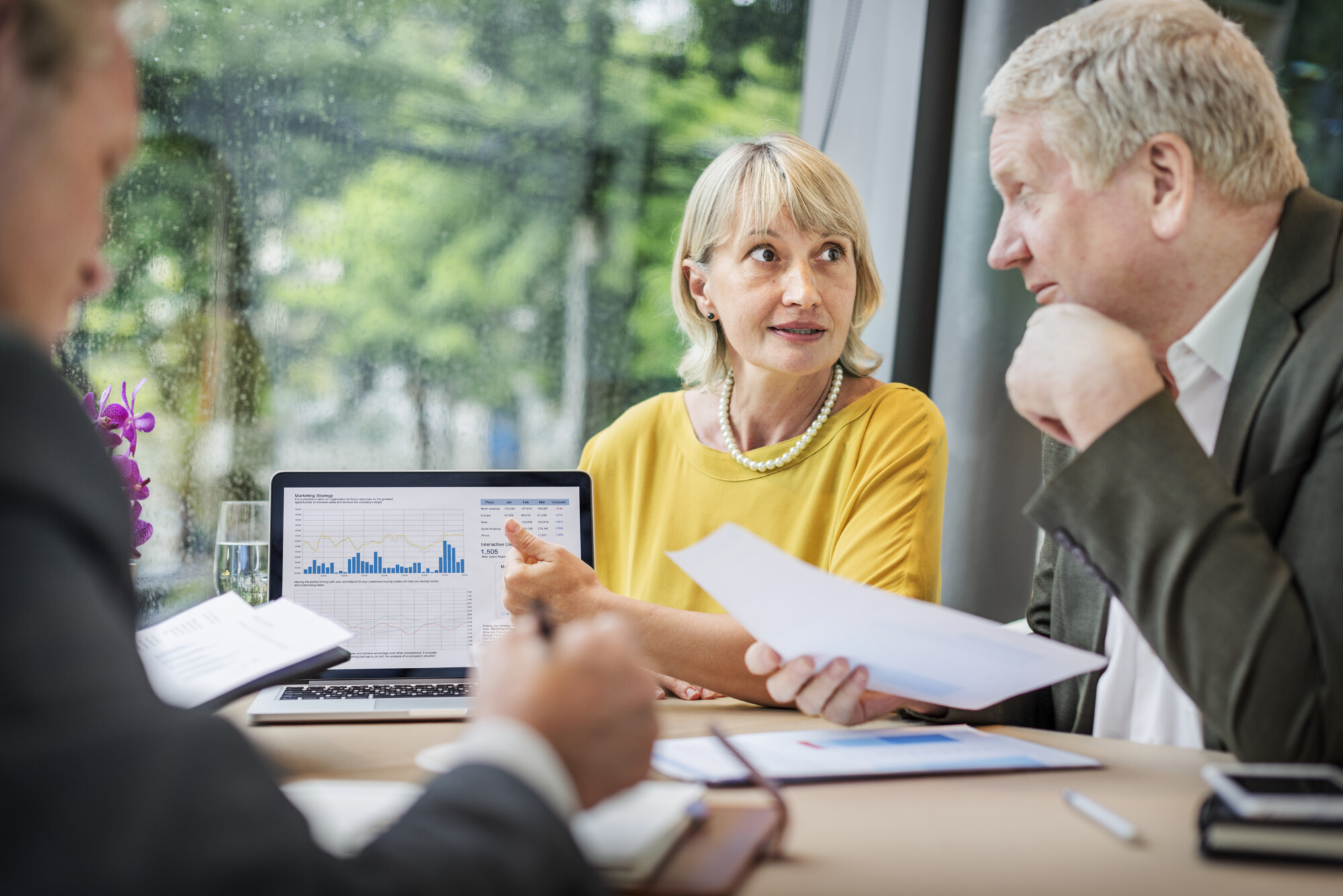 Accountant reviewing VAT calculations with business owners