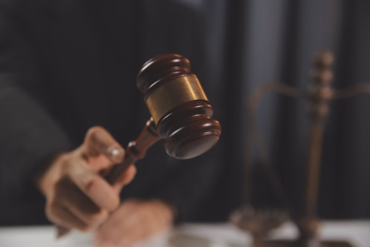 Judge holding a gavel in a courtroom