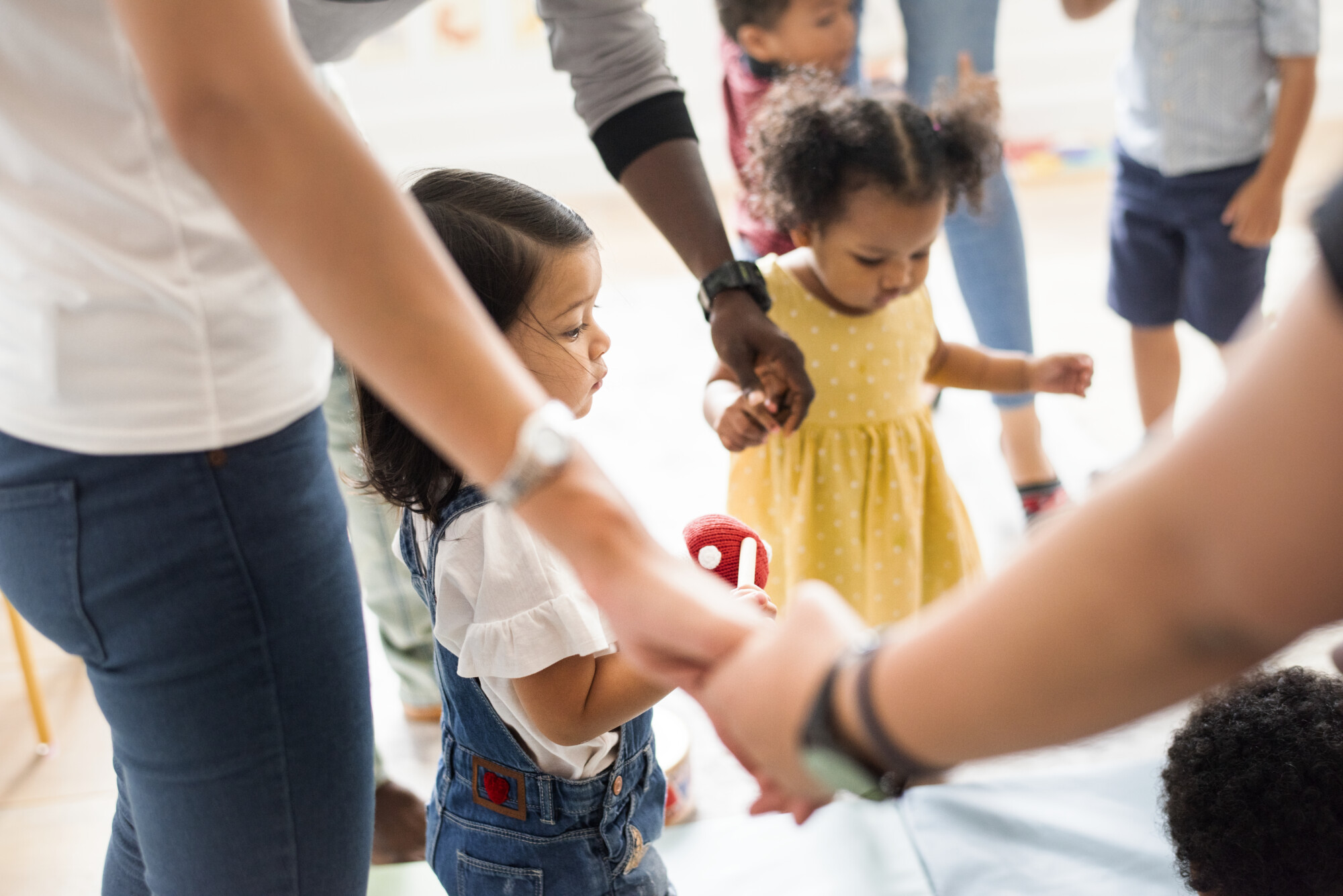 Young children standing with their parents