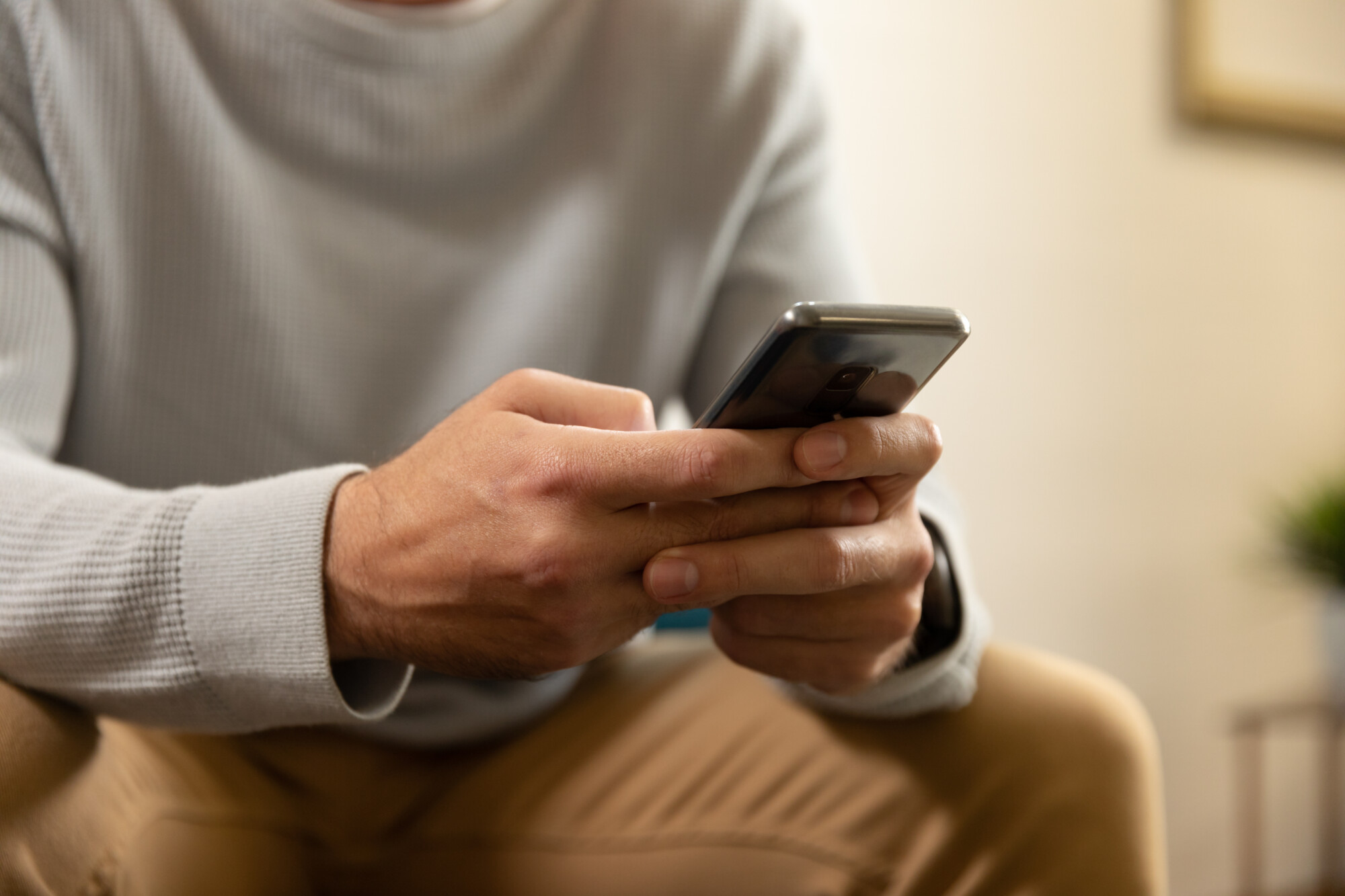 Person using a smartphone for multi-factor authentication.