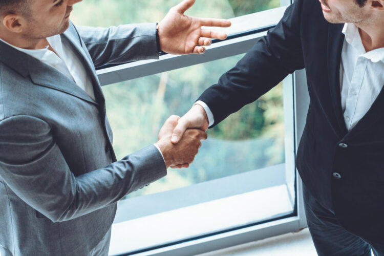 LLP members shaking hands on partnership agreement