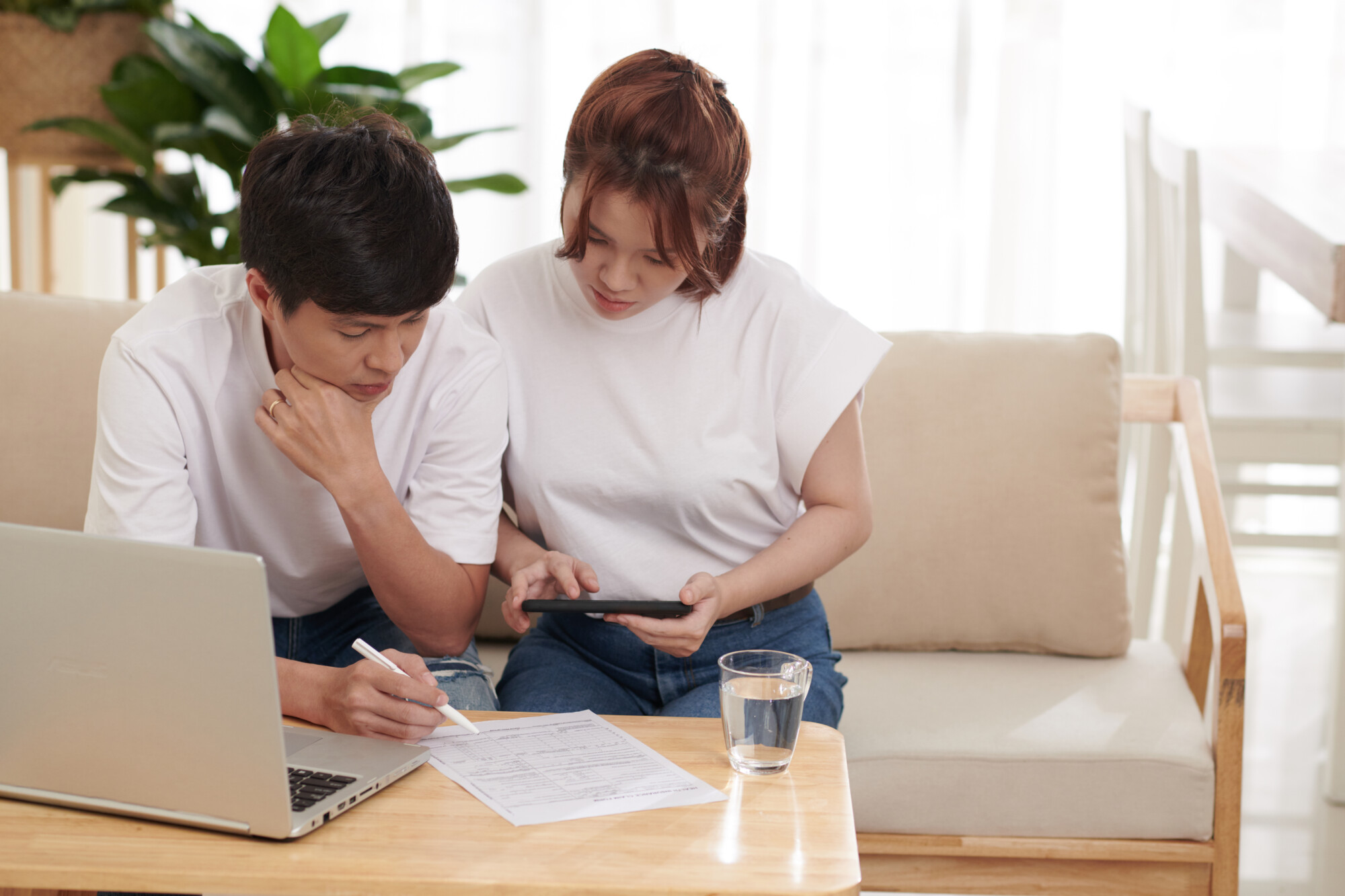 Couple checking NI refund claim details online at home