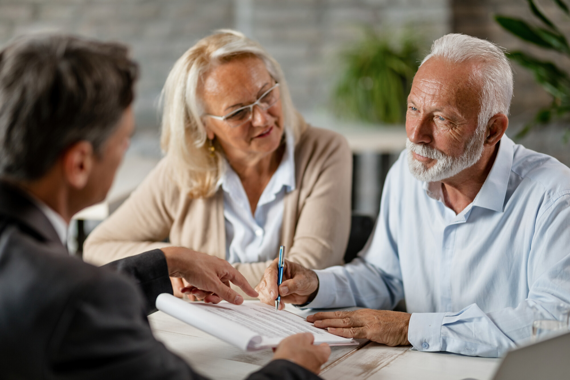 Couple meeting with a professional advisor to review inheritance tax documents